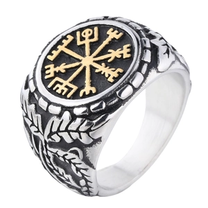 Detail of Viking Vegvisir compass ring with silver floral carving and golden symbol