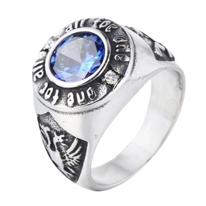Detail of vintage men's ring with blue gemstone and engraved all for one quote