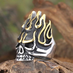 Macro detail of retro skull ring with golden flame accents and vintage silver finish