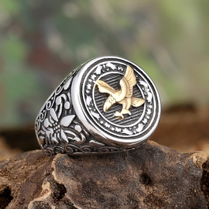 Macro view of men's vintage steel eagle signet ring showing detailed side carvings