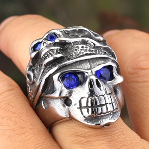 Vintage punk skull ring for men in retro steel with four blue sapphire-like stones