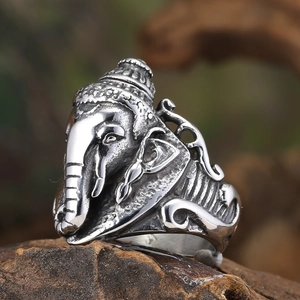 Detailed macro shot of vintage stainless steel Ganesha elephant god ring on wood