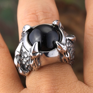 Retro punk dragon claw ring in stainless steel with a round black stone on hand