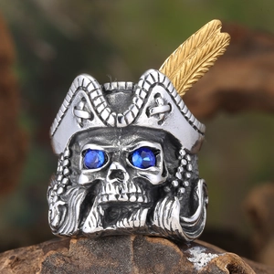 Macro detail of pirate skull ring featuring blue gem eyes and gold feather hat