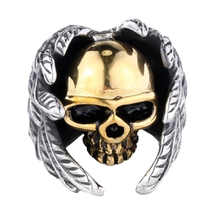 Detailed close-up of a punk style stainless steel ring with golden skull and silver wings