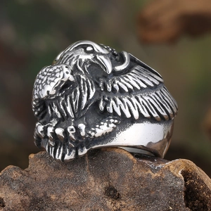 Macro shot of vintage stainless steel ring with intricate embossed raven wing textures