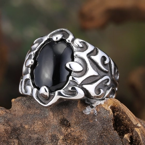 Vintage stainless steel ring for men featuring a large oval black stone and floral engravings