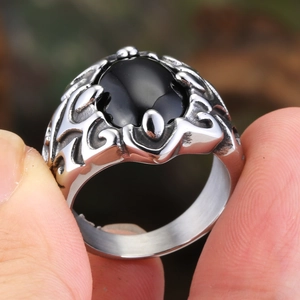 Retro punk titanium steel ring featuring a black oval stone and vine floral engravings