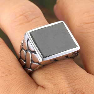 Retro men's signet ring with square black stone and embossed woven texture on silver band