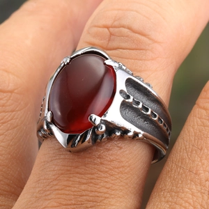 Punk vintage ring with dark red oval agate stone on a textured antique silver band