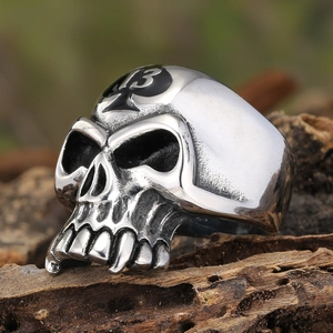 Macro detail of gothic skull ring with black spade 13 engraving on vintage silver finish