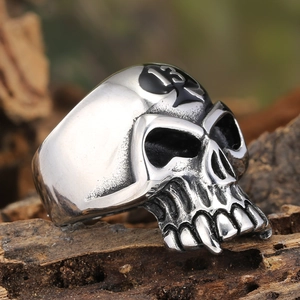 Vintage silver skull ring for men with spade 13 engraving on a rustic wood background