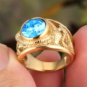 Macro detail of vintage gold ring with blue gemstone and scale texture