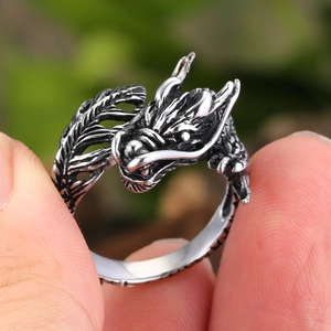 Macro detail of retro silver dragon ring showing intricate scales and dragon head carving