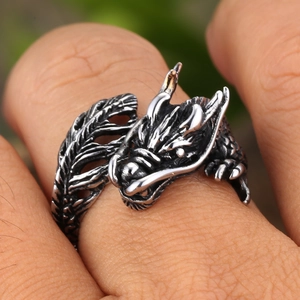 Retro dragon-shaped stainless steel wrap ring with antique finish on a male finger