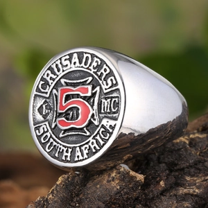 Macro shot of silver retro Crusaders MC shield ring on rustic wood background