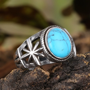 Detail of vintage steel ring featuring turquoise stone and star hollow patterns