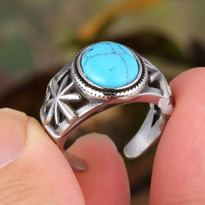Vintage titanium steel ring featuring an oval turquoise stone with hollow star patterns