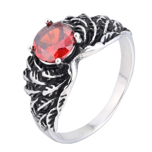Macro shot of retro wing ring featuring a large round red gemstone and vintage texture