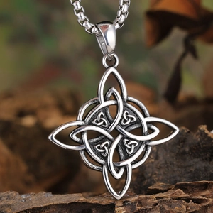 Macro shot of retro silver Celtic witch knot pendant on a vintage steel chain link