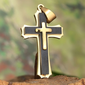 Three-layer titanium steel cross necklace with gold and black composite design on tree bark