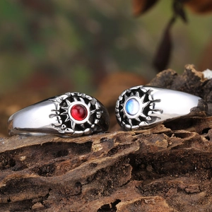 Retro silver rings with red and blue gemstones on wood base, vintage bohemian jewelry set