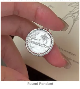 Macro detail of a S925 sterling silver coin pendant featuring stars and future engraving