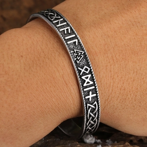 Detailed close-up of Viking Mjolnir cuff bracelet with Rune carvings and Celtic knots