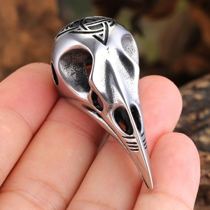 Vintage stainless steel viking crow skull ring featuring a black celtic triquetra knot design