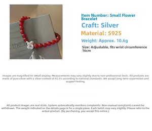 Close-up of S925 sterling silver flower charm on a red agate beaded bracelet