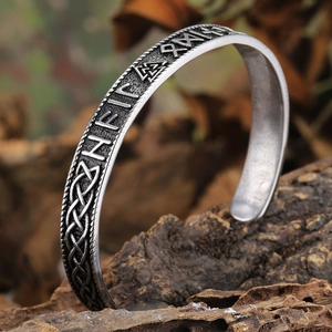 Detailed macro shot of Viking runes and Celtic knot engraving on a vintage bangle