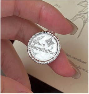 Macro detail of S925 silver star pendant with Future Expectation engraving and rope edge