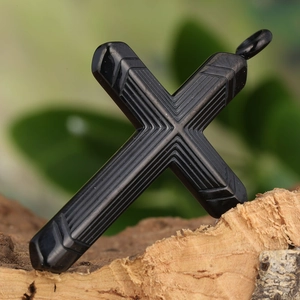 Minimalist black titanium steel cross necklace with vertical textures on a wooden base