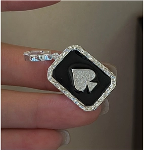 Detailed view of S925 silver spade pendant with black enamel and white crystals