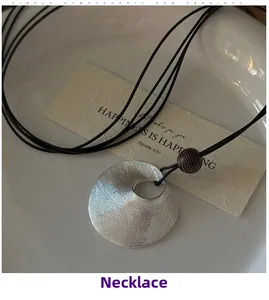 Detailed close-up of S925 sterling silver brushed texture pendant with a brown wooden bead
