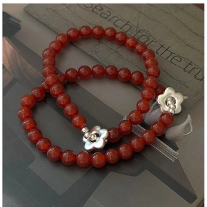 Detail of S925 silver flower charms on retro red agate beaded bracelets set