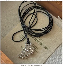 Close-up of S925 silver grape cluster pendant with adjustable black woven cord necklace