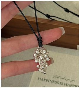 Close-up of S925 silver grape cluster pendant with adjustable black woven cord necklace