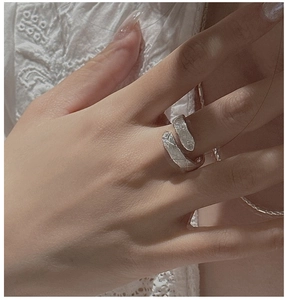 Detail of S925 sterling silver cross textured ring with tiny cubic zirconia accents