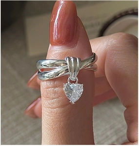 Close-up of S925 silver heart zircon ring with layered cross band and three-prong setting