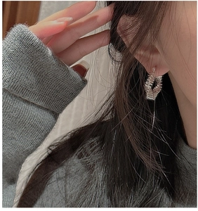 Close-up of S925 sterling silver hoop earrings with vintage pleated texture on a model