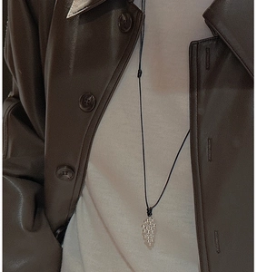 S925 silver grape cluster pendant on adjustable black cord worn over leather jacket