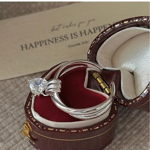 Detail of silver S925 heart zircon open ring inside a vintage red jewelry gift box