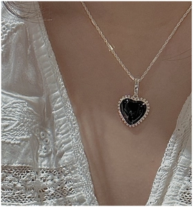 Close-up of S925 sterling silver black heart pendant necklace on woman's neck