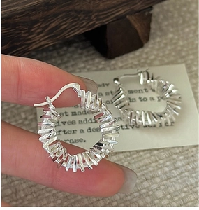 Detailed shot of S925 sterling silver hoop earrings with vintage wrinkled spiral texture