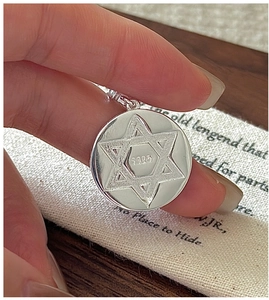 Macro shot of S925 sterling silver hexagram pendant showing the brushed finish and hallmark