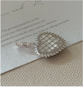 Macro detail of S925 sterling silver heart pendant featuring hollow grid back and hallmark