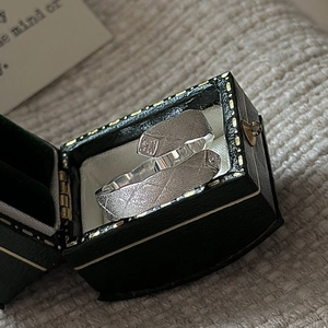 Minimalist S925 sterling silver couple rings with matte texture in a vintage jewelry box