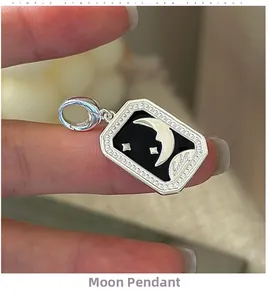 Close-up of S925 sterling silver moon and star pendant with black enamel rectangular design