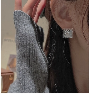 Close-up of S925 sterling silver square stud earrings with textured geometric design